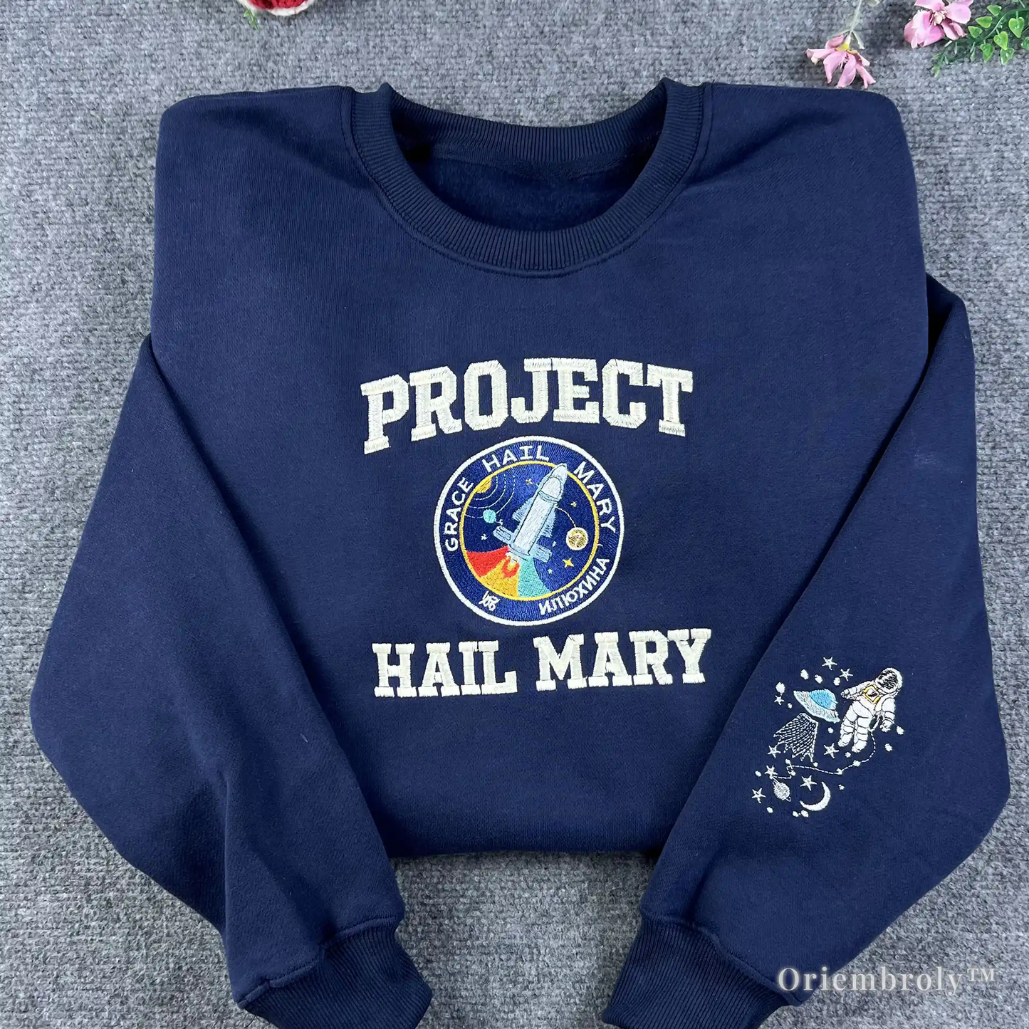 Premium navy blue crewneck sweatshirt with "Project Hail Mary" collegiate embroidery and mission patch. A must-have for fans of Andy Weir’s sci-fi novel and space exploration books