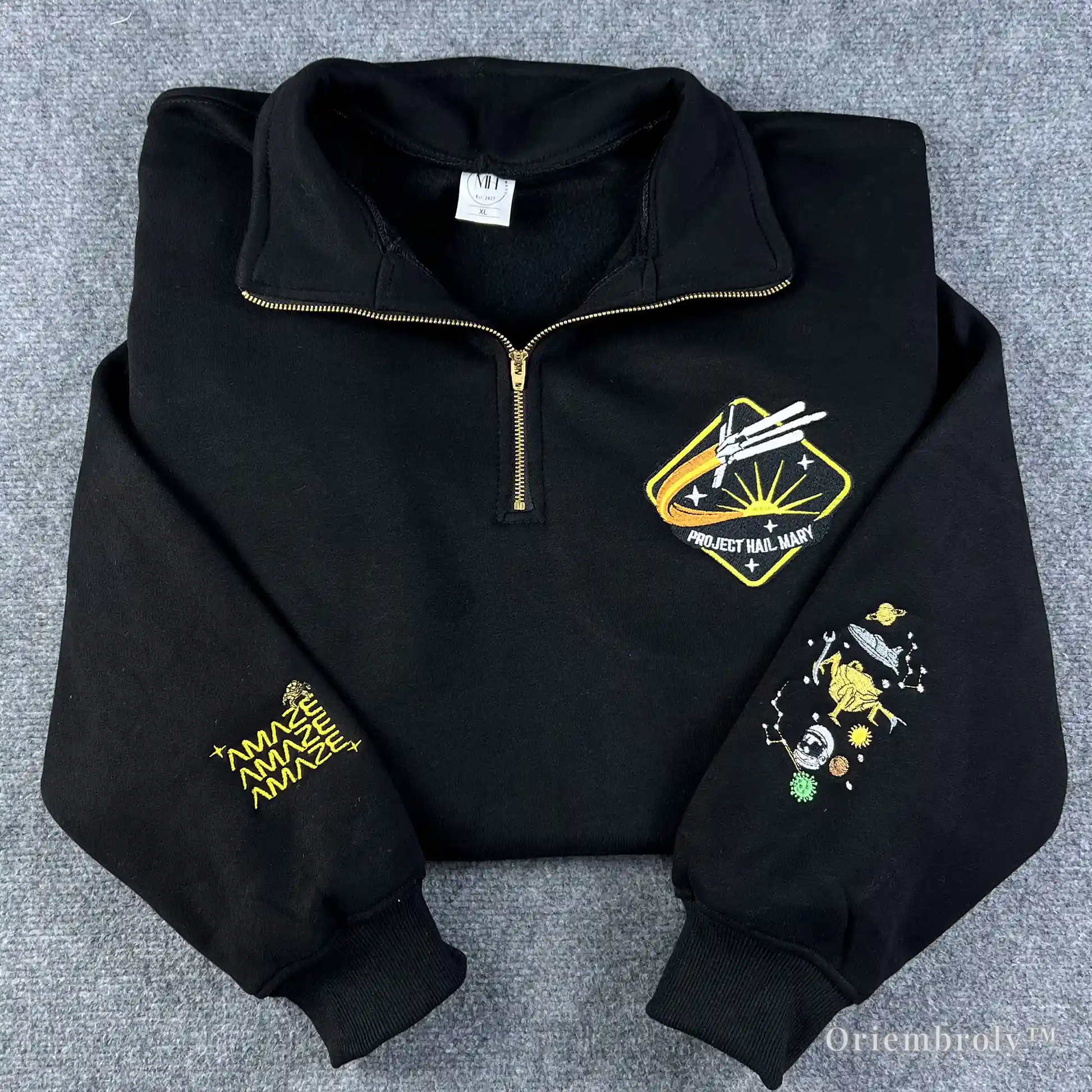 A high-quality black quarter-zip sweatshirt featuring embroidered Project Hail Mary mission patch and Rocky the Eridian illustration on the sleeve. Perfect gift for Andy Weir sci-fi fans and book lovers.
