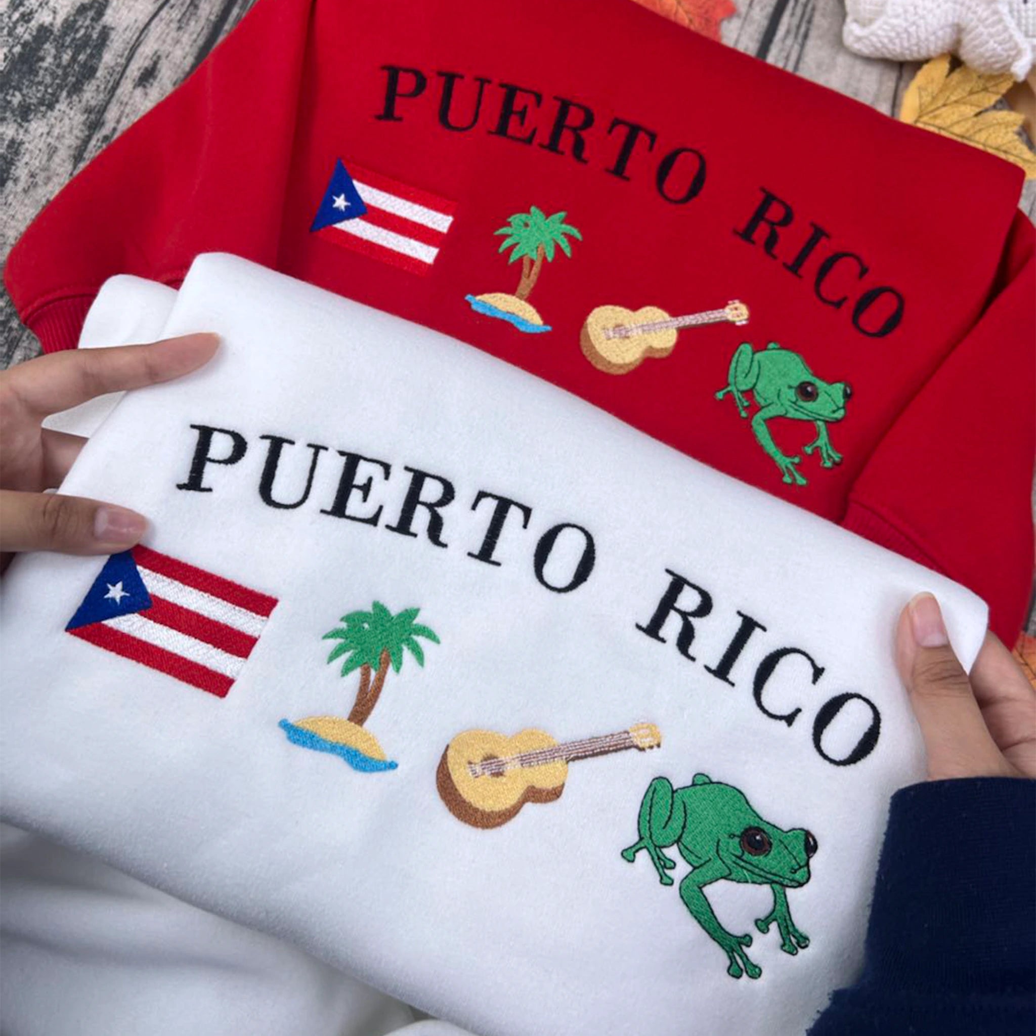 Puerto Rico embroidery sweatshirt featuring Boricua culture symbols like Taino designs, Coquí frog, guitar, palm tree, and island flag. Black cotton crewneck, soft and stylish.