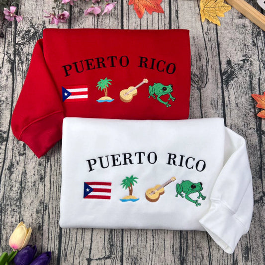 Puerto Rico embroidery sweatshirt featuring Boricua culture symbols like Taino designs, Coquí frog, guitar, palm tree, and island flag. Black cotton crewneck, soft and stylish.