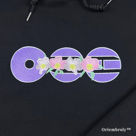 purple circular symbol embroidery on black hoodie
