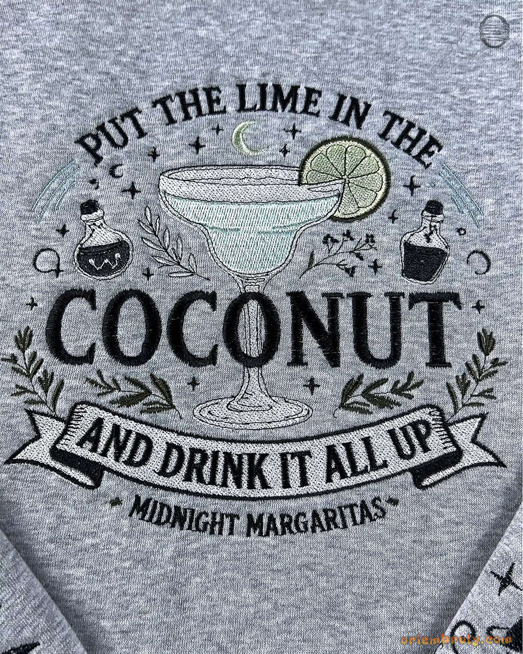 Close-up of Put The Lime In The Coconut Midnight Margaritas embroidery design on a grey sweatshirt