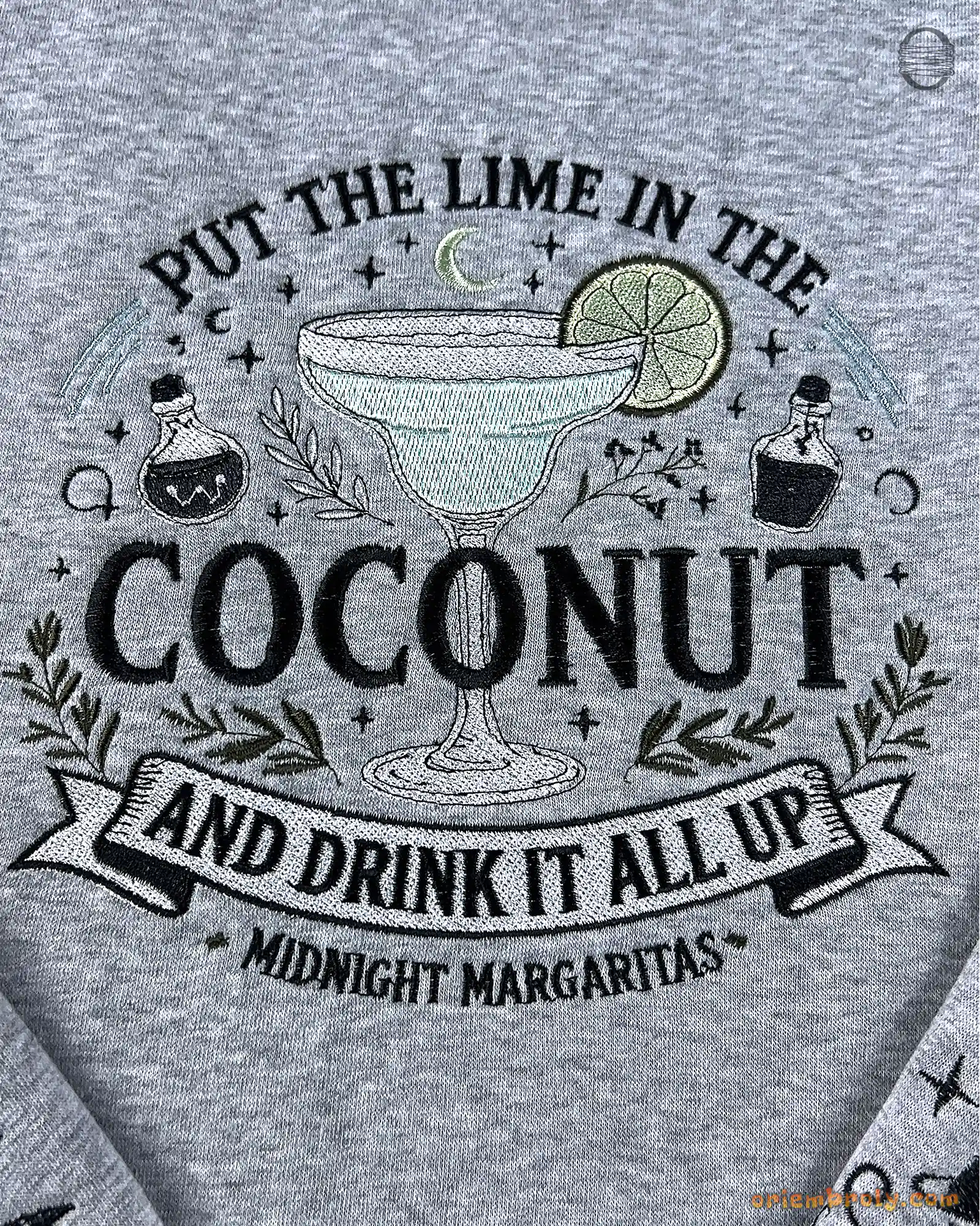 Close-up of Put The Lime In The Coconut Midnight Margaritas embroidery design on a grey sweatshirt