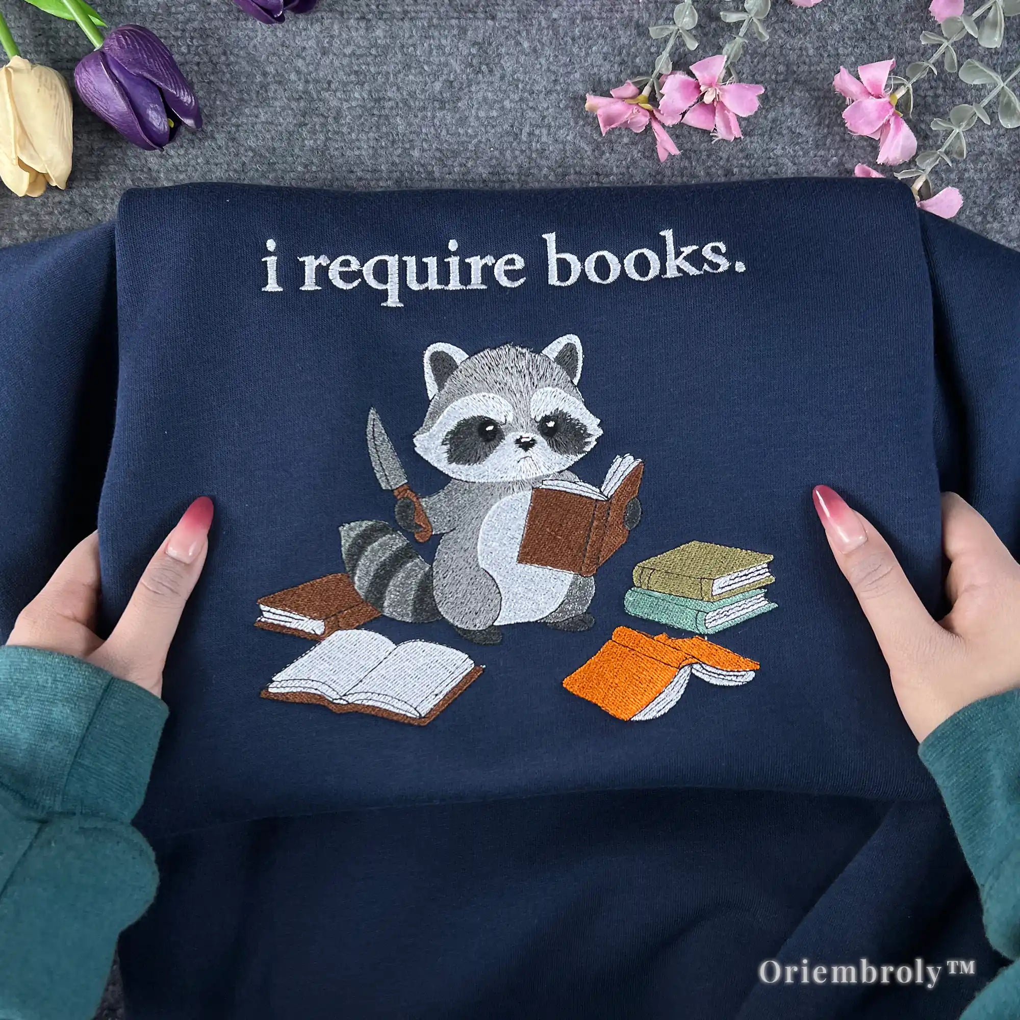 raccoon embroidered sweatshirt reading book design