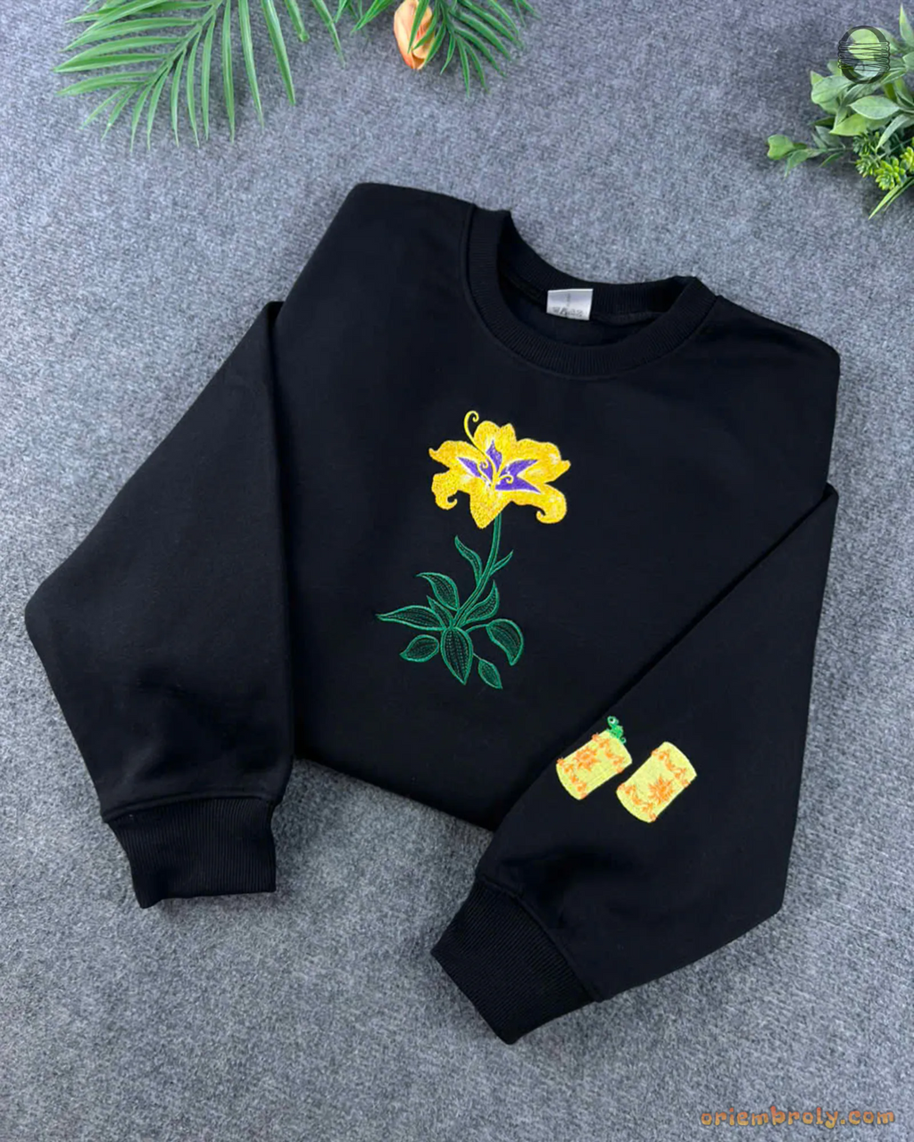 Black Rapunzel crewneck sweatshirt embroidered with a magical yellow lily flower and custom sleeve lantern details