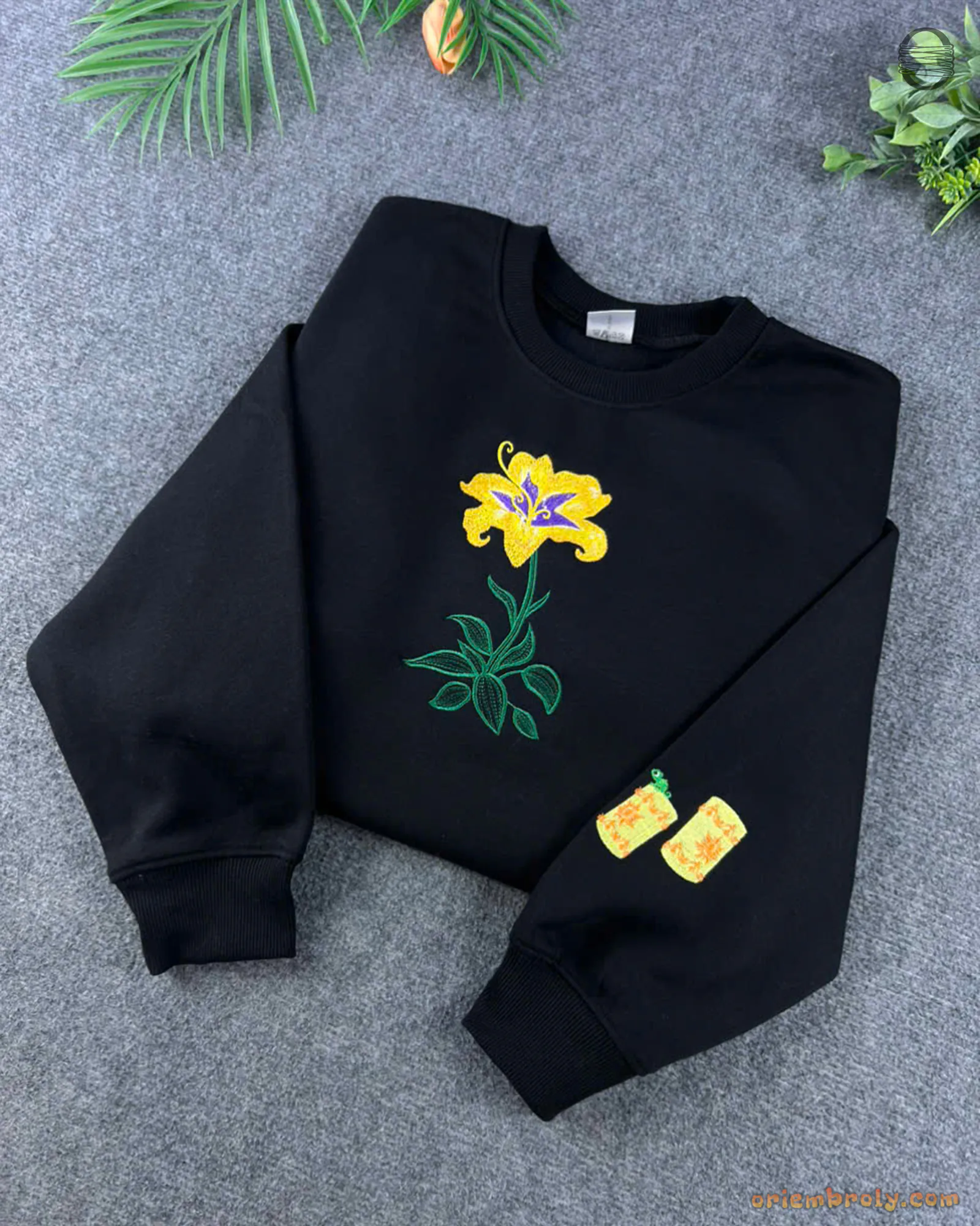Black Rapunzel crewneck sweatshirt embroidered with a magical yellow lily flower and custom sleeve lantern details