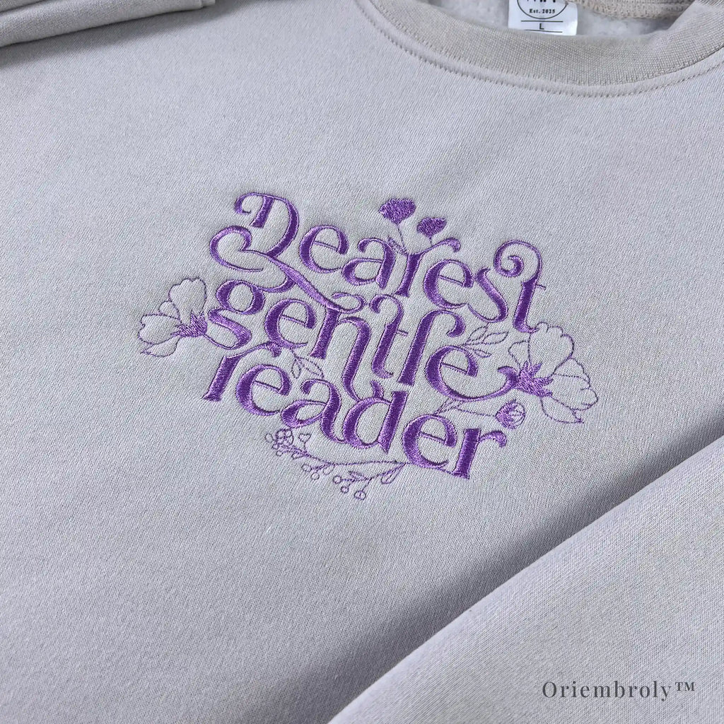 book lover wearing embroidered literary sweatshirt at home