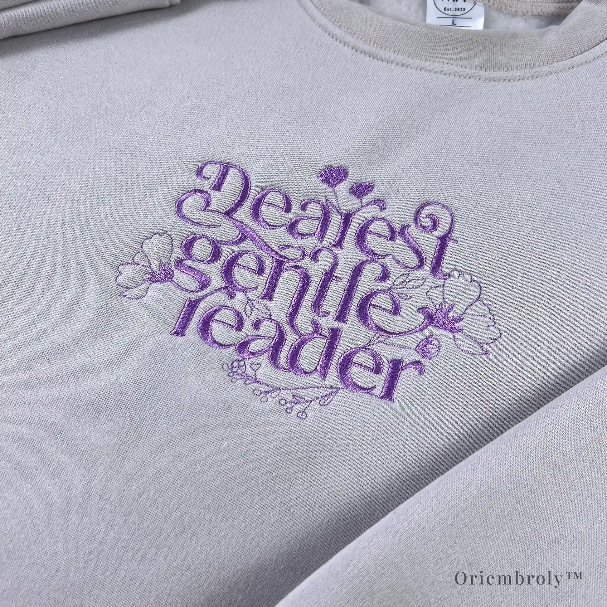 book lover wearing embroidered literary sweatshirt at home