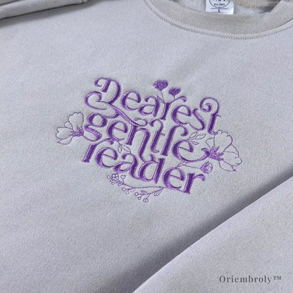 book lover wearing embroidered literary sweatshirt at home