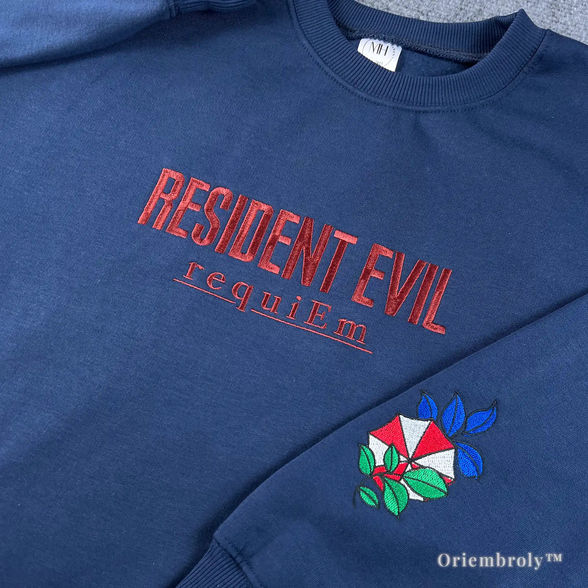 Unisex navy crewneck sweater featuring Resident Evil Biohazard red embroidery and sleeve patch.