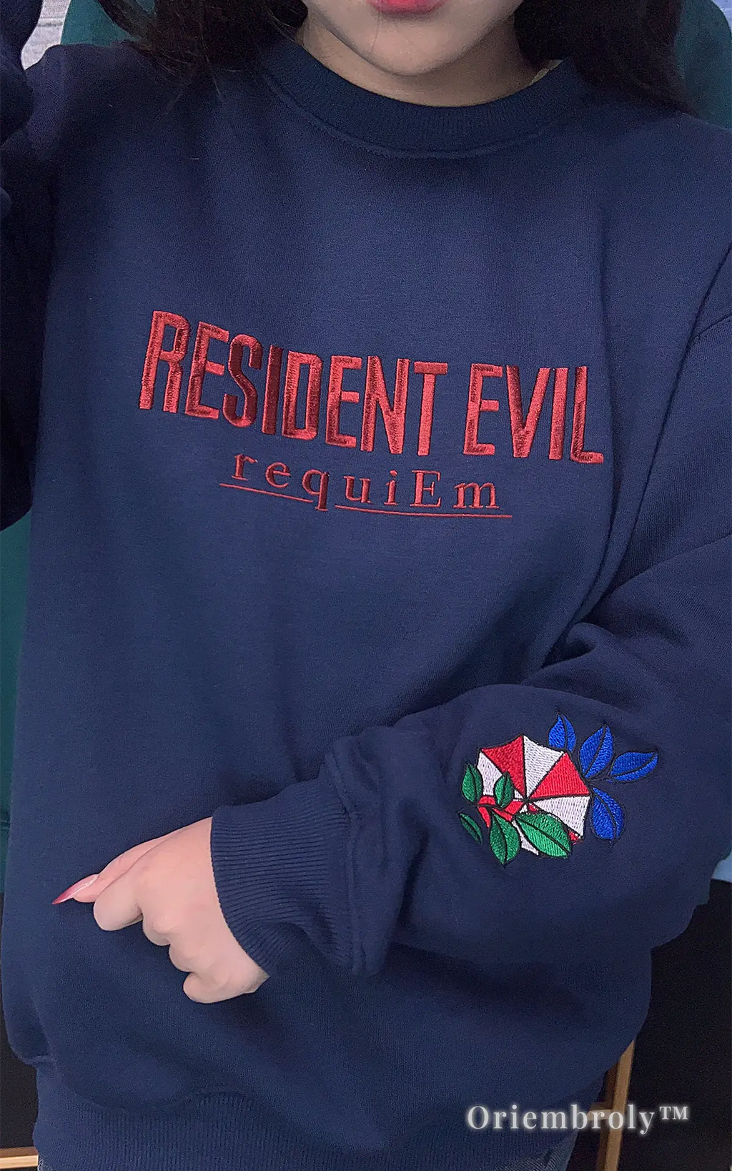 Resident Evil gaming merch navy fleece sweatshirt with aesthetic sleeve embroidery detail.