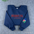 Navy Resident Evil Umbrella Corp embroidered sweatshirt with red lettering and sleeve logo.