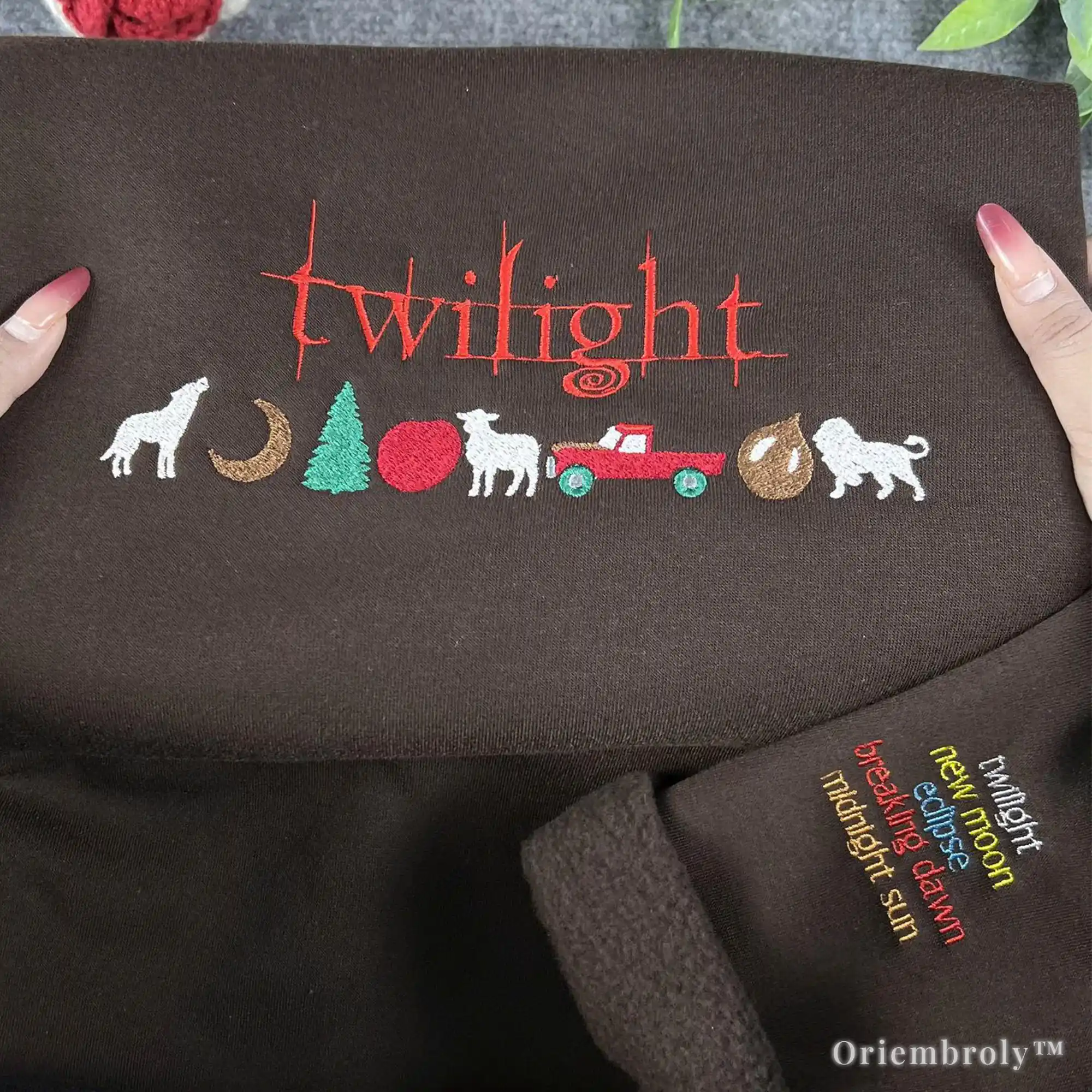 Embroidered design of 'Twilight' series elements on a brown fabric with 'Oriembroly' branding.