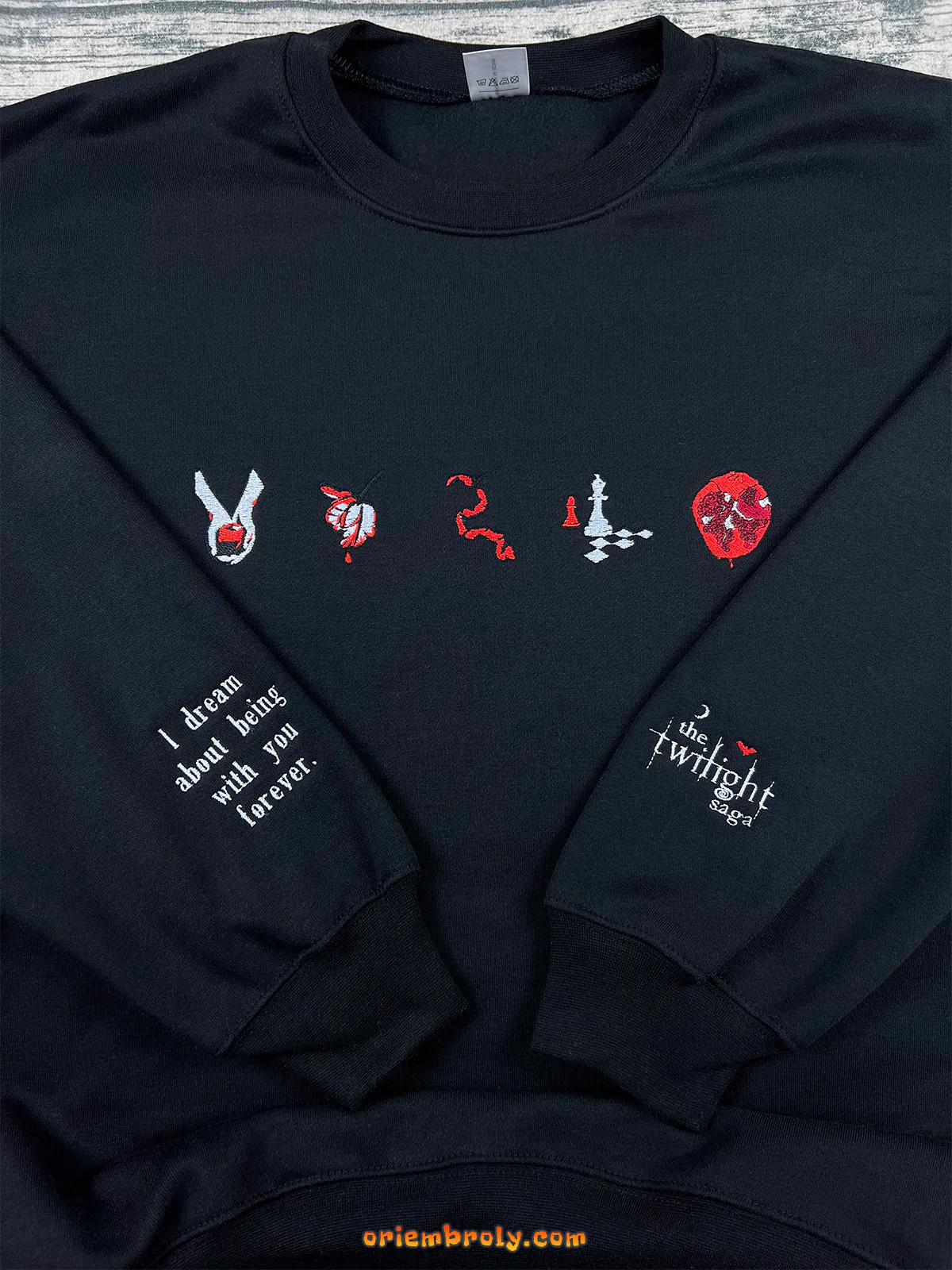 Symbolic fantasy book icons embroidered on crewneck