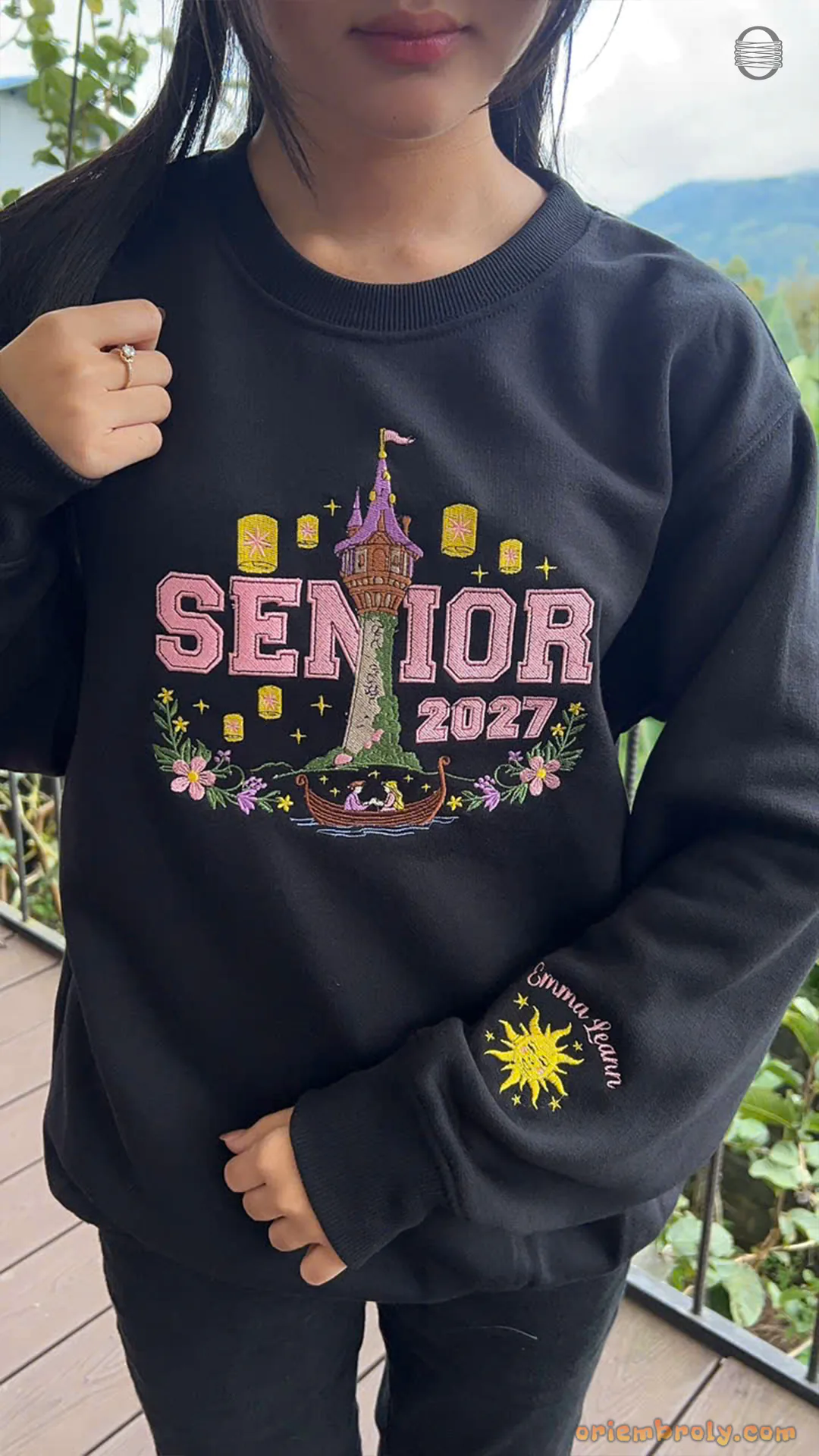 Front view of model wearing a black Senior 2027 Rapunzel themed sweatshirt for high school graduation outfit
