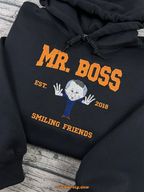 Black hoodie with embroidered winking caricature