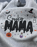 Detailed view of fine embroidery stitching on a light gray Spooky MAMA Halloween sweatshirt.