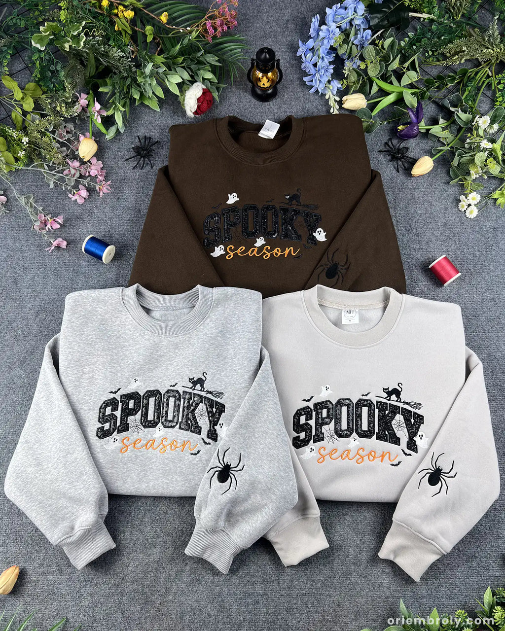 Spooky season embroidered sweatshirt collection in brown, heather grey, and sand featuring sequined text and spider sleeve detail in USA.