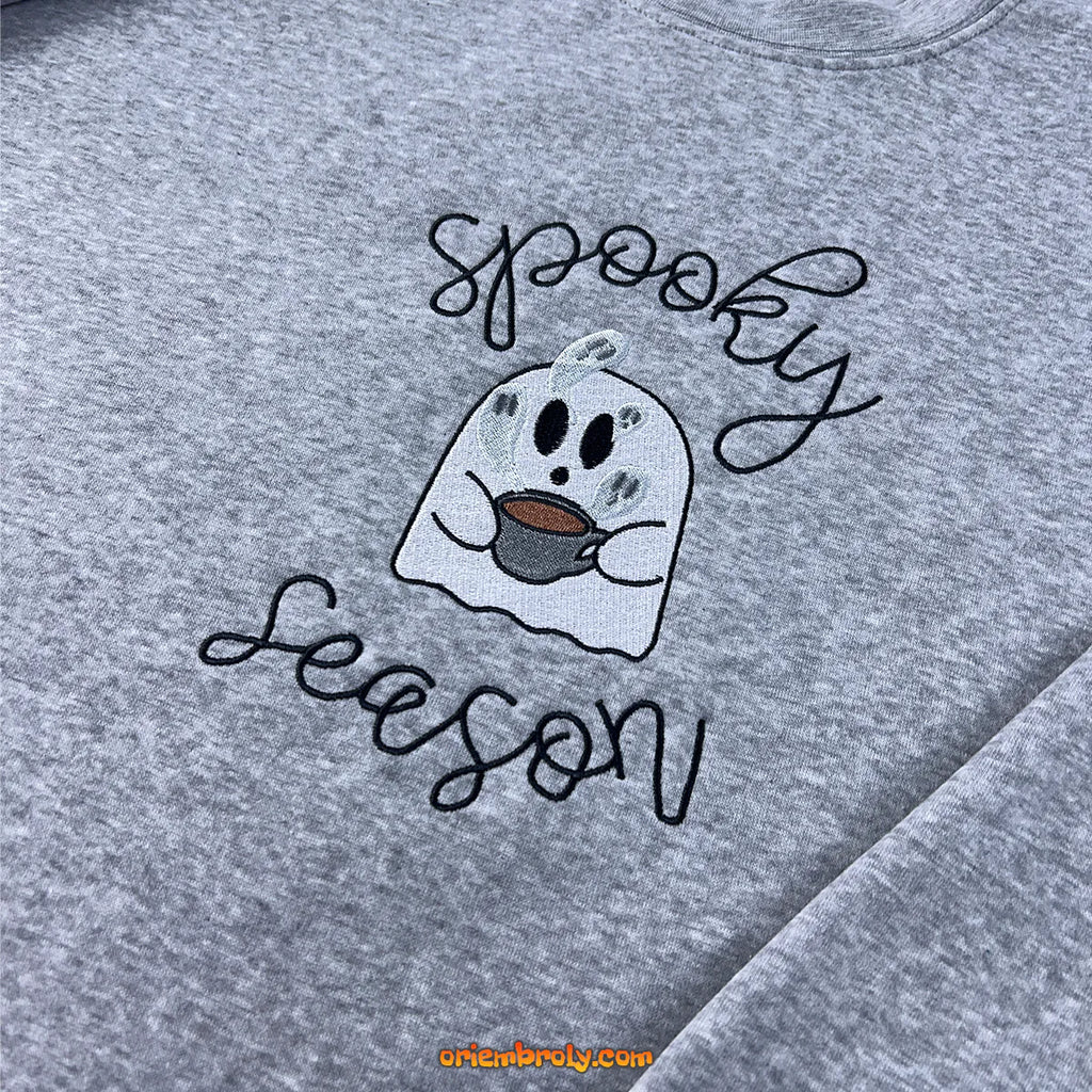 Halloween flatlay of spooky embroidered hoodie with fall decor