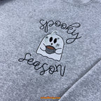 Halloween flatlay of spooky embroidered hoodie with fall decor
