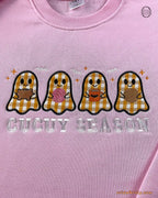 Close-up of Spooky Season applique embroidery with cute orange, brown, and pink plaid ghosts on a light pink sweatshirt