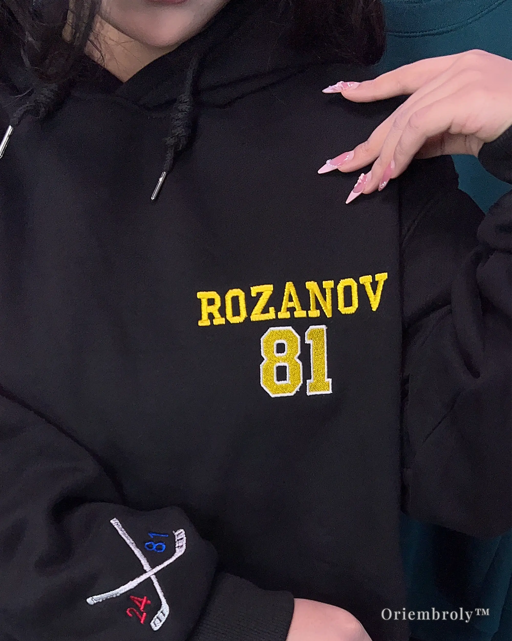 hockey fan wearing embroidered jersey style hoodie