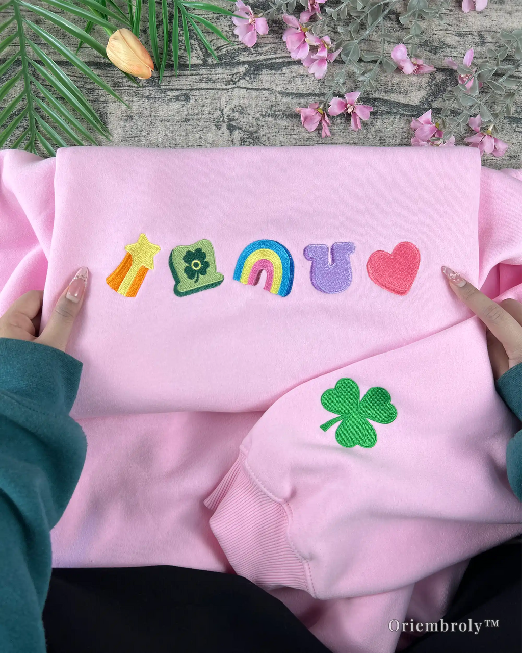 green clover embroidery detail on sweatshirt sleeve