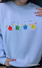 High-quality Stardew Valley merch: Embroidered Junimo sweatshirt in soft light blue fabric.