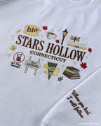 Close-up of Stars Hollow Connecticut embroidery with autumn coffee cup graphics and embroidered quote on the sleeve cuff.