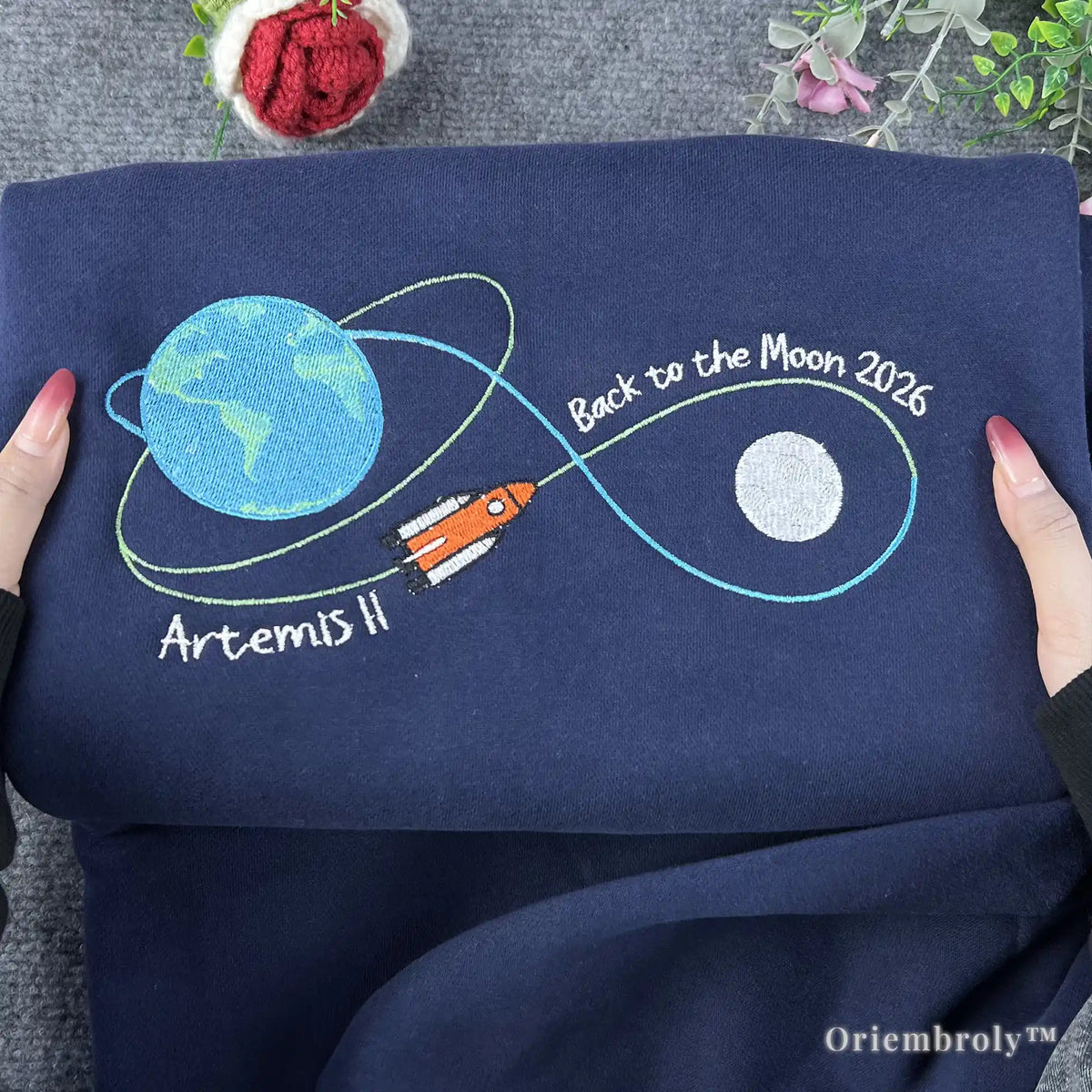 STEM-core aesthetic navy pullover with a colorful embroidered rocket ship and orbital trajectory. Minimalist and stylish NASA-inspired fashion for daily wear or campus life