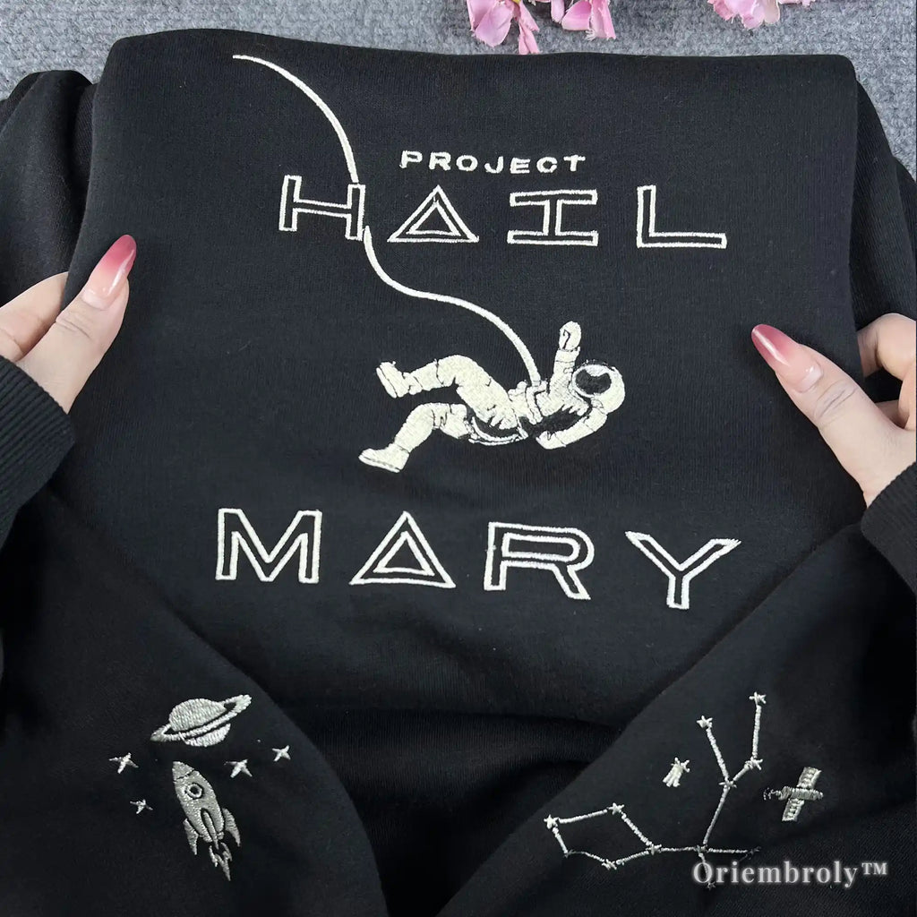 STEM-core aesthetic black pullover with white embroidered astronaut and rocket ship motifs. Minimalist and stylish space-themed streetwear for science teachers, engineers, and astronomy enthusiasts