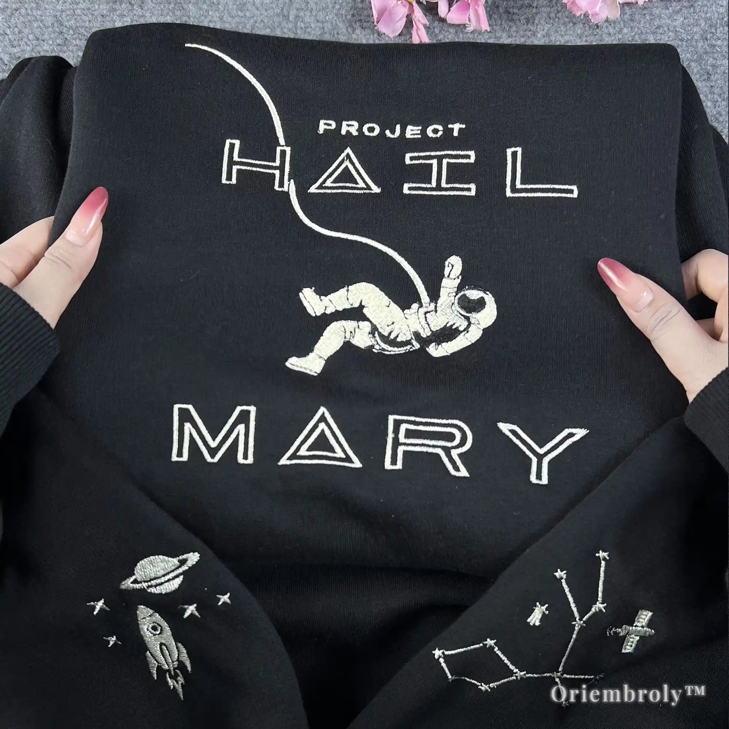 STEM-core aesthetic black pullover with white embroidered astronaut and rocket ship motifs. Minimalist and stylish space-themed streetwear for science teachers, engineers, and astronomy enthusiasts