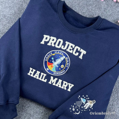STEM-core aesthetic navy sweatshirt with a central Hail Mary mission patch embroidery. Stylish and educational space-themed apparel for science teachers, physics students, and engineers