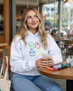 White Super Mario Galaxy hoodie featuring colorful embroidered Luma characters