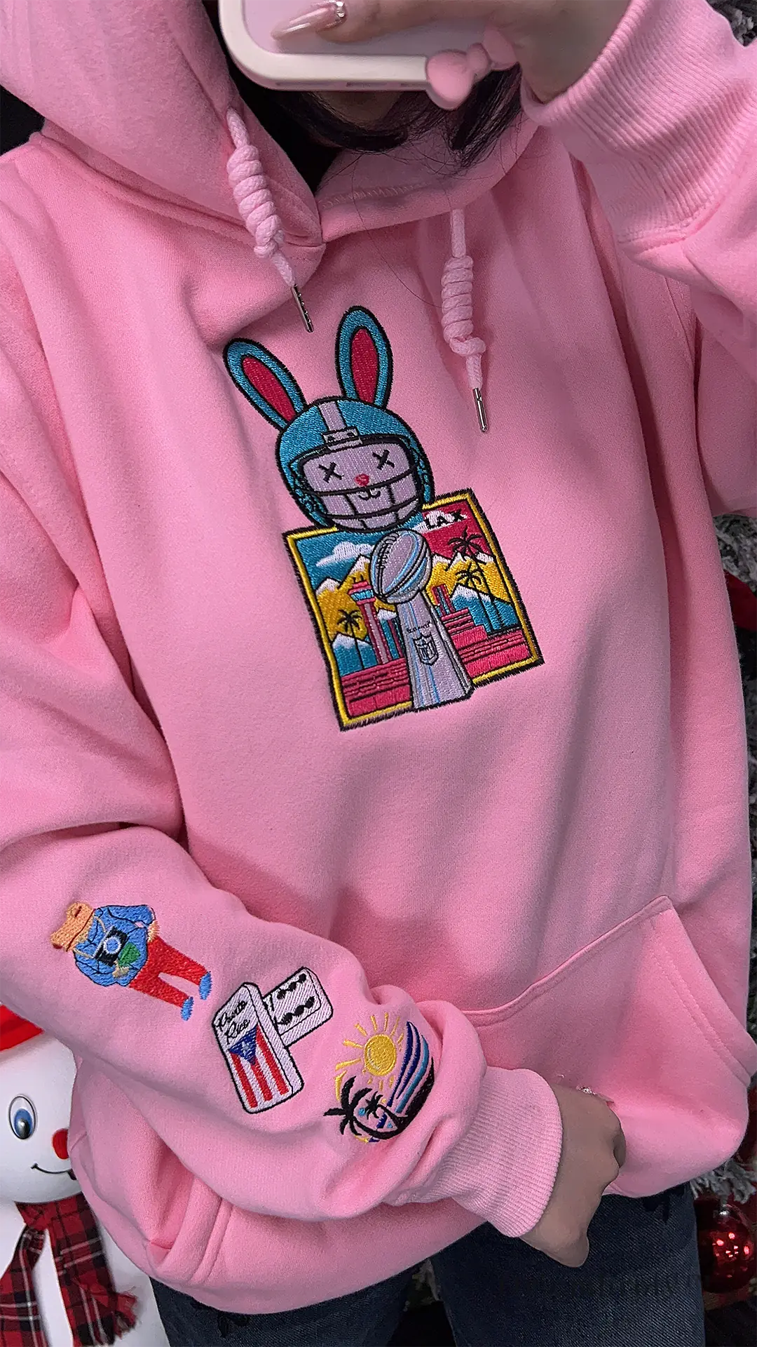 Pink Puerto Rican flag patch on left sleeve of Benito hoodie Model