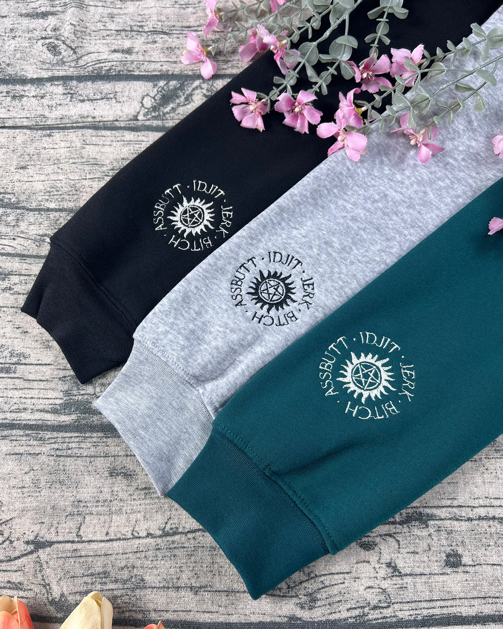 Supernatural embroidered sweatshirt featuring Dean, Sam, and Castiel design.