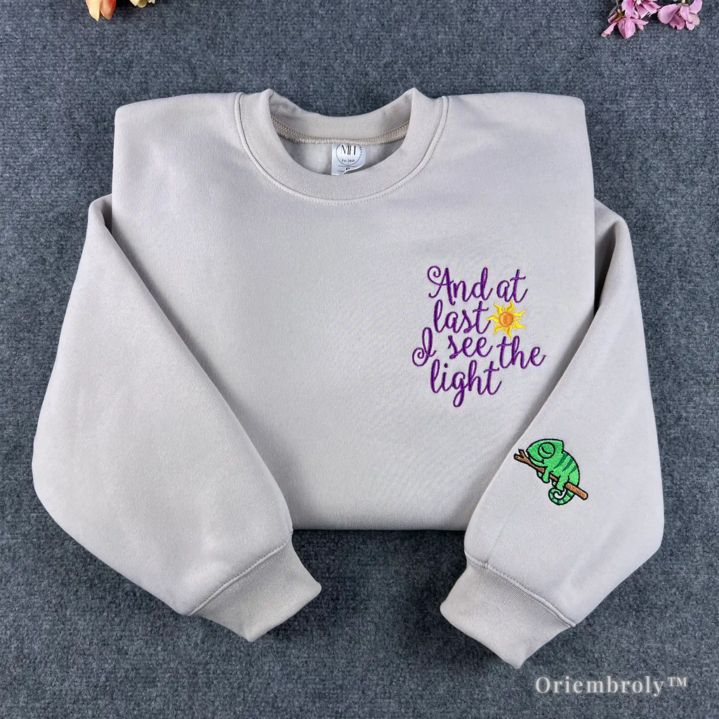 Cream Tangled "And at last I see the light" embroidered sweatshirt with Pascal on sleeve.