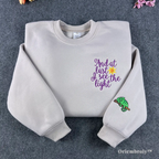 Cream Tangled "And at last I see the light" embroidered sweatshirt with Pascal on sleeve.