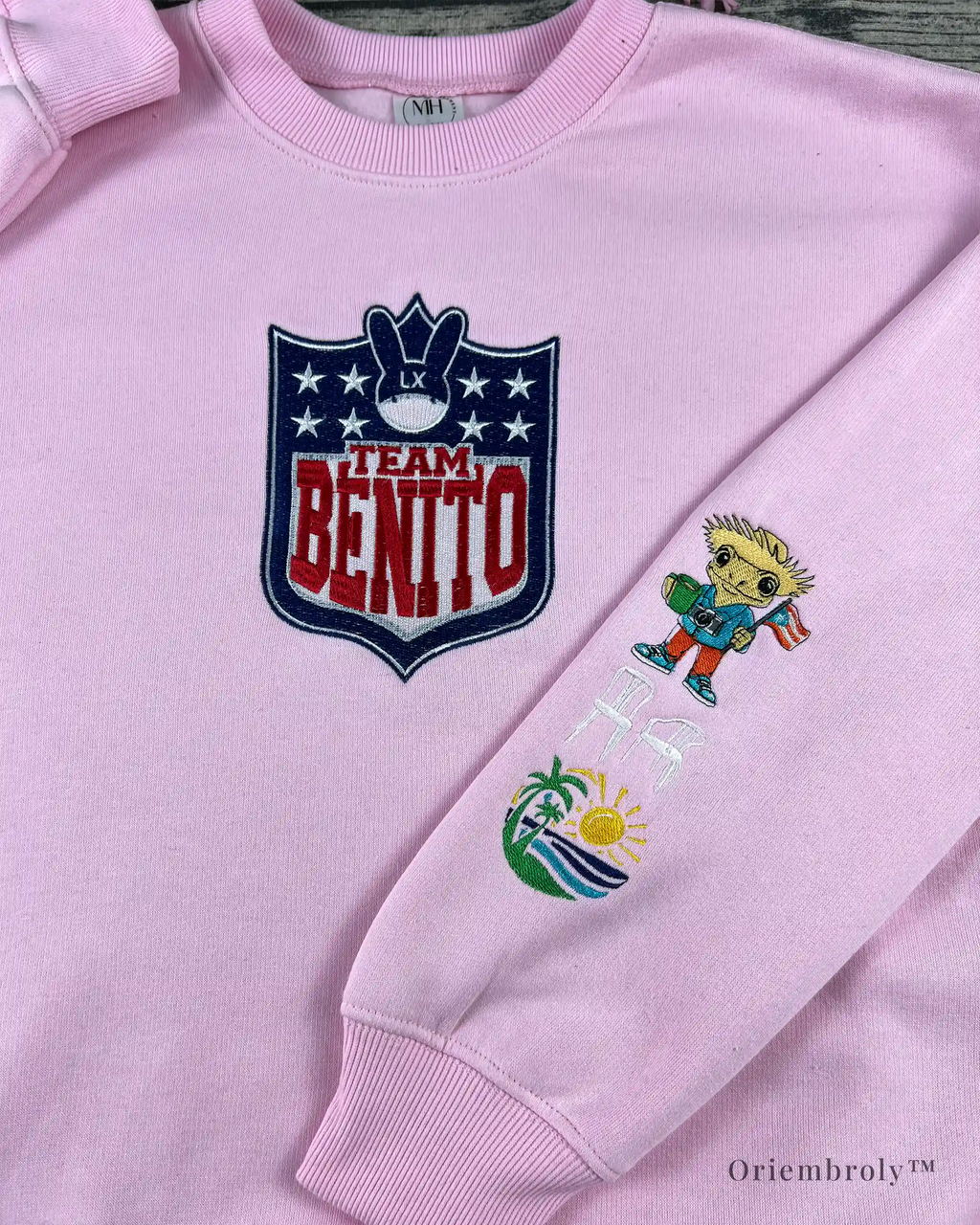 Football-style shield crest embroidery on Team Benito crewneck