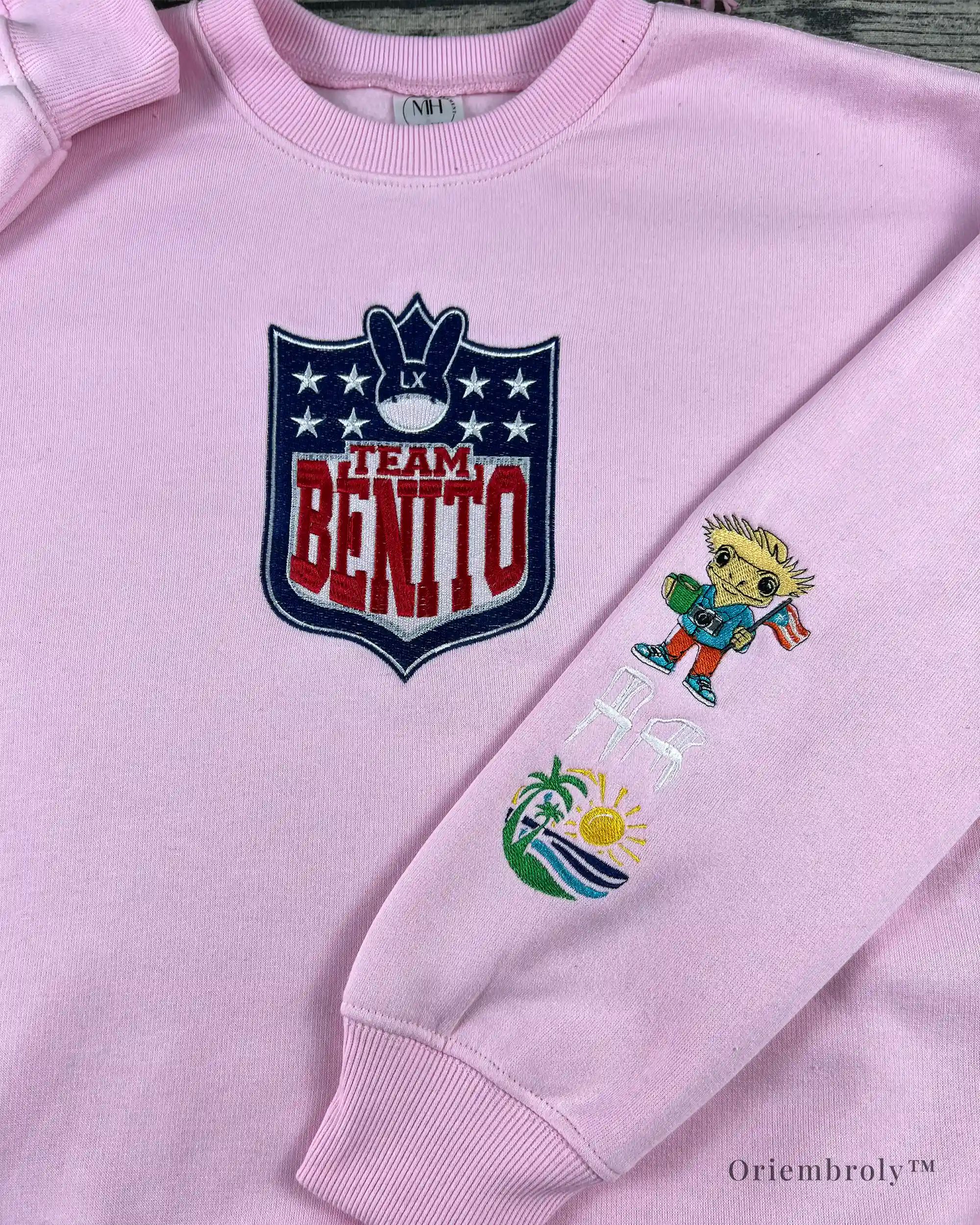 Football-style shield crest embroidery on Team Benito crewneck