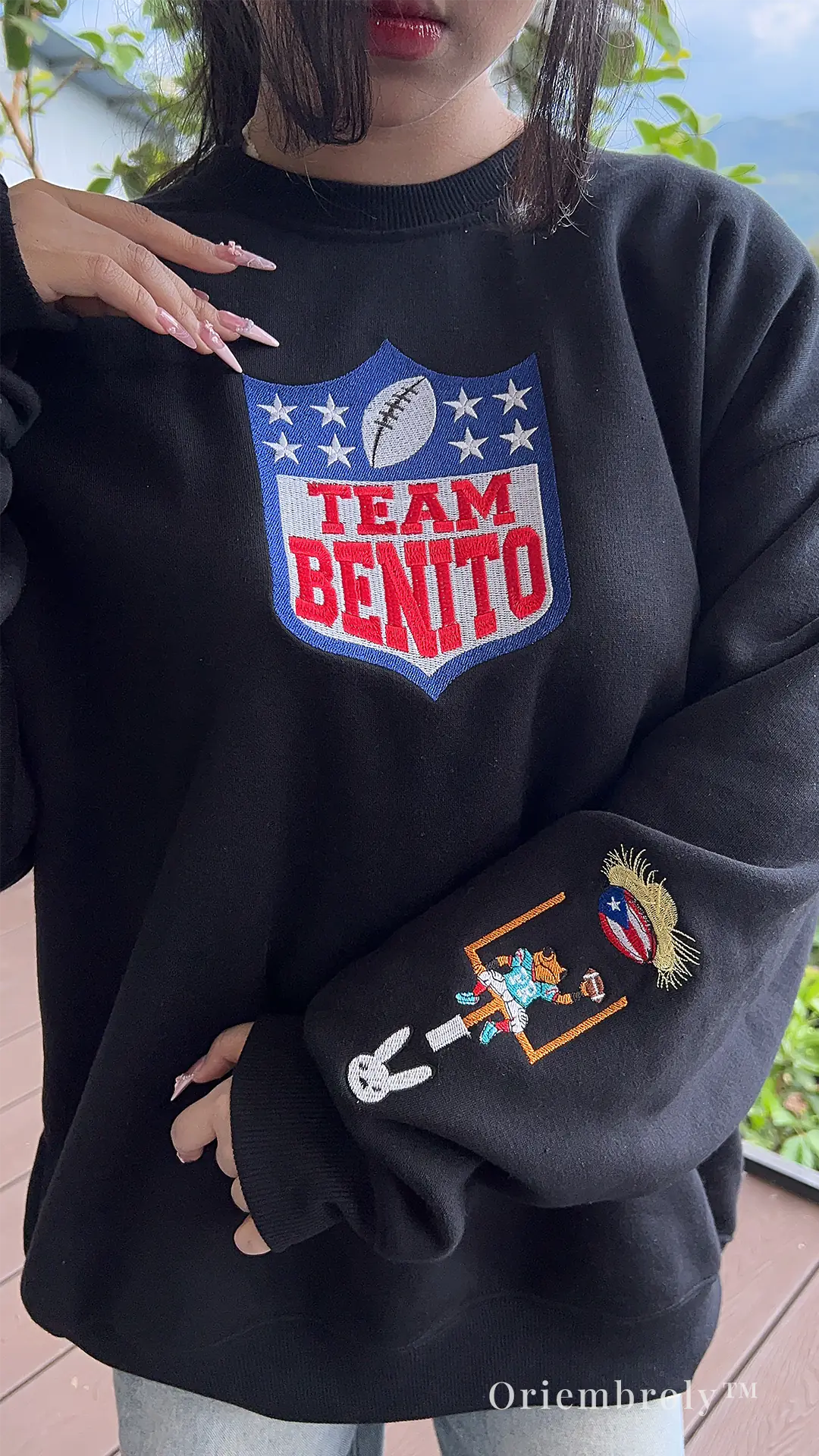 football fan wearing embroidered Team Benito sweatshirt