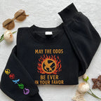 The Hunger Games embroidered sweatshirt featuring May The Odds Be Ever In Your Favor design, perfect hoodie gift for book lovers.