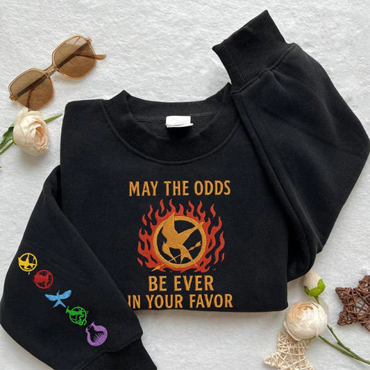 The Hunger Games embroidered sweatshirt featuring May The Odds Be Ever In Your Favor design, perfect hoodie gift for book lovers.