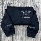 The Shatter Me crewneck sweatshirt, custom embroidered Kishimoto Sector 45 uniform design, featuring A Warner. Perfect for book lovers and fans of Hell Is Empty shirt