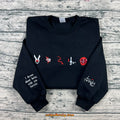 Black crewneck with book inspired embroidered symbols