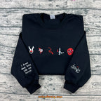 Black crewneck with book inspired embroidered symbols