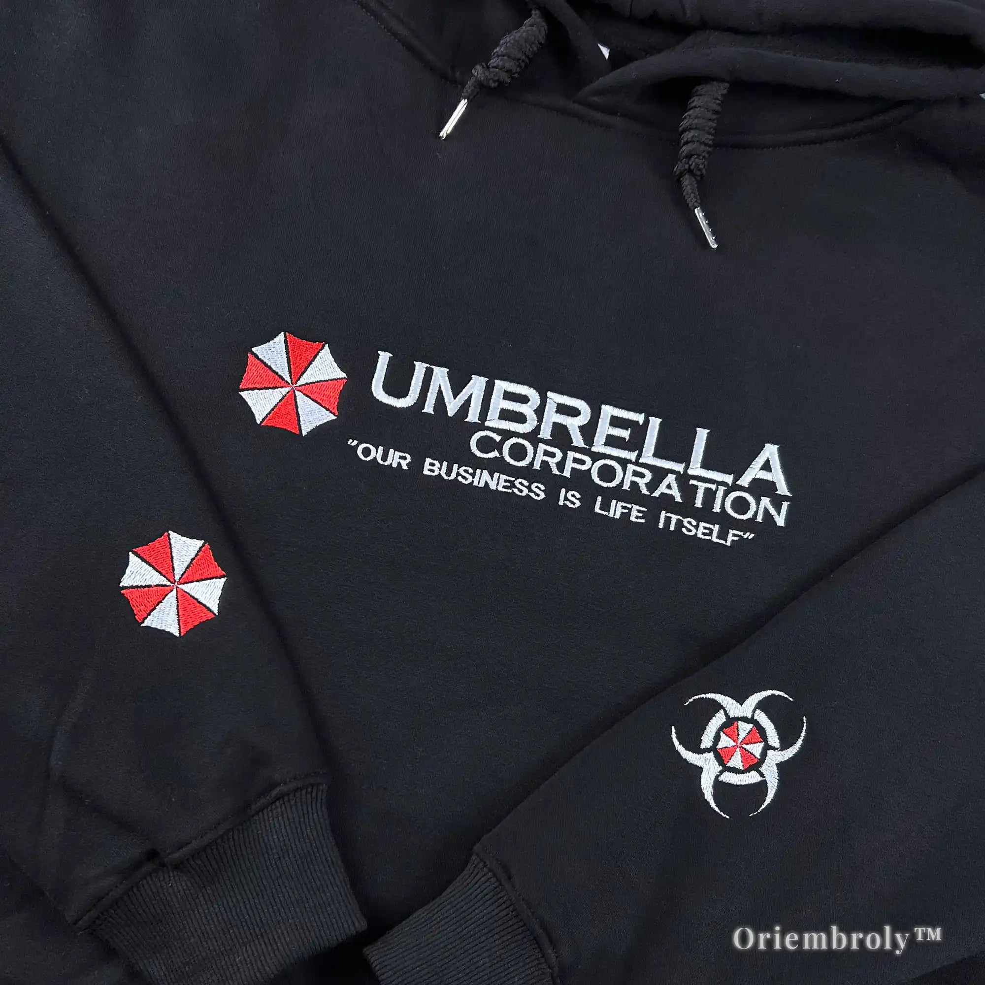 Our Business is Life Itself" Umbrella Corp black hoodie featuring biohazard embroidery