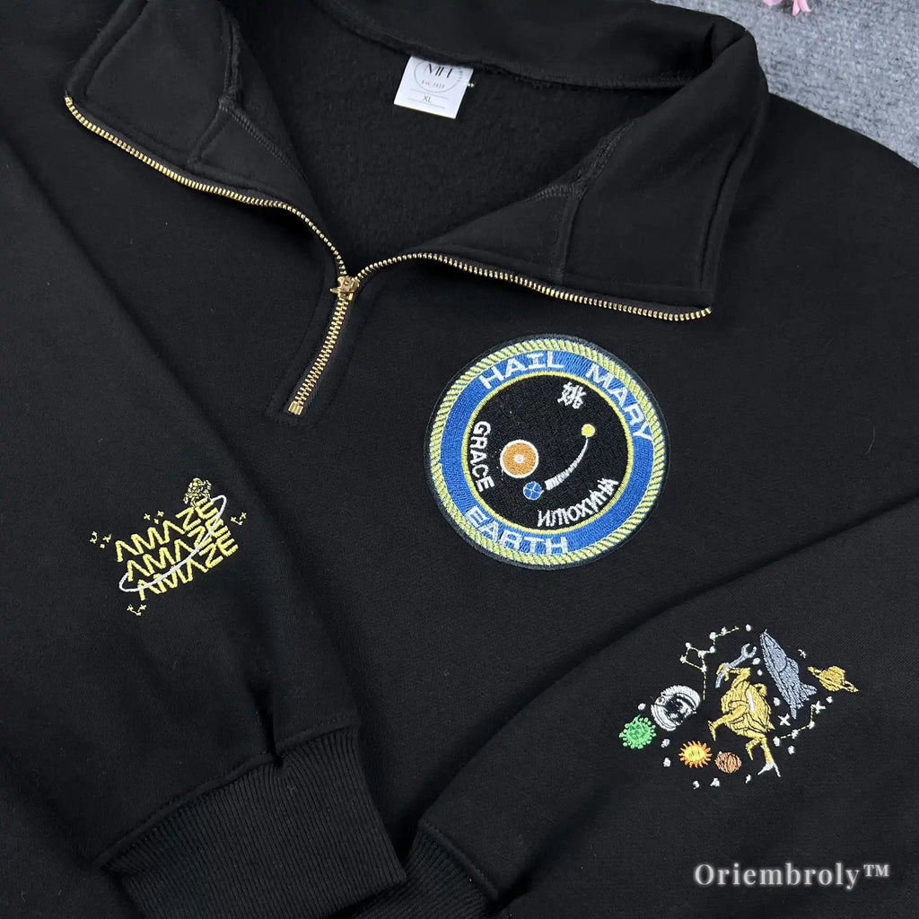 Detailed embroidery of an astronaut and Eridian spaceship on a black fleece quarter-zip. A thoughtful and high-quality gift idea for science fiction lovers and astronomy enthusiasts