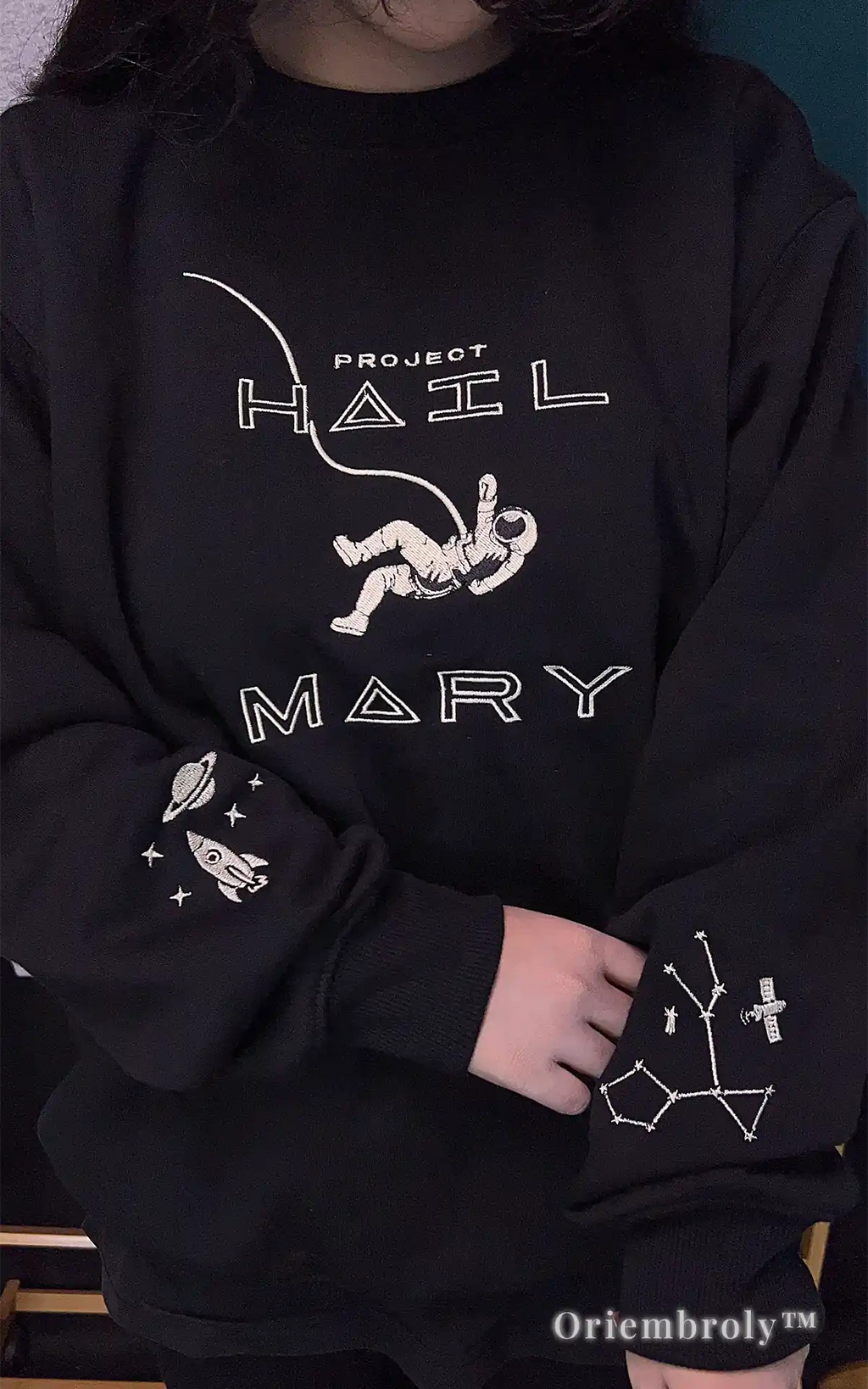 Custom embroidered Project Hail Mary themed sweater in black. Features detailed astronaut, planet, and star chart embroidery on sleeves. A thoughtful and high-quality gift for sci-fi book club members