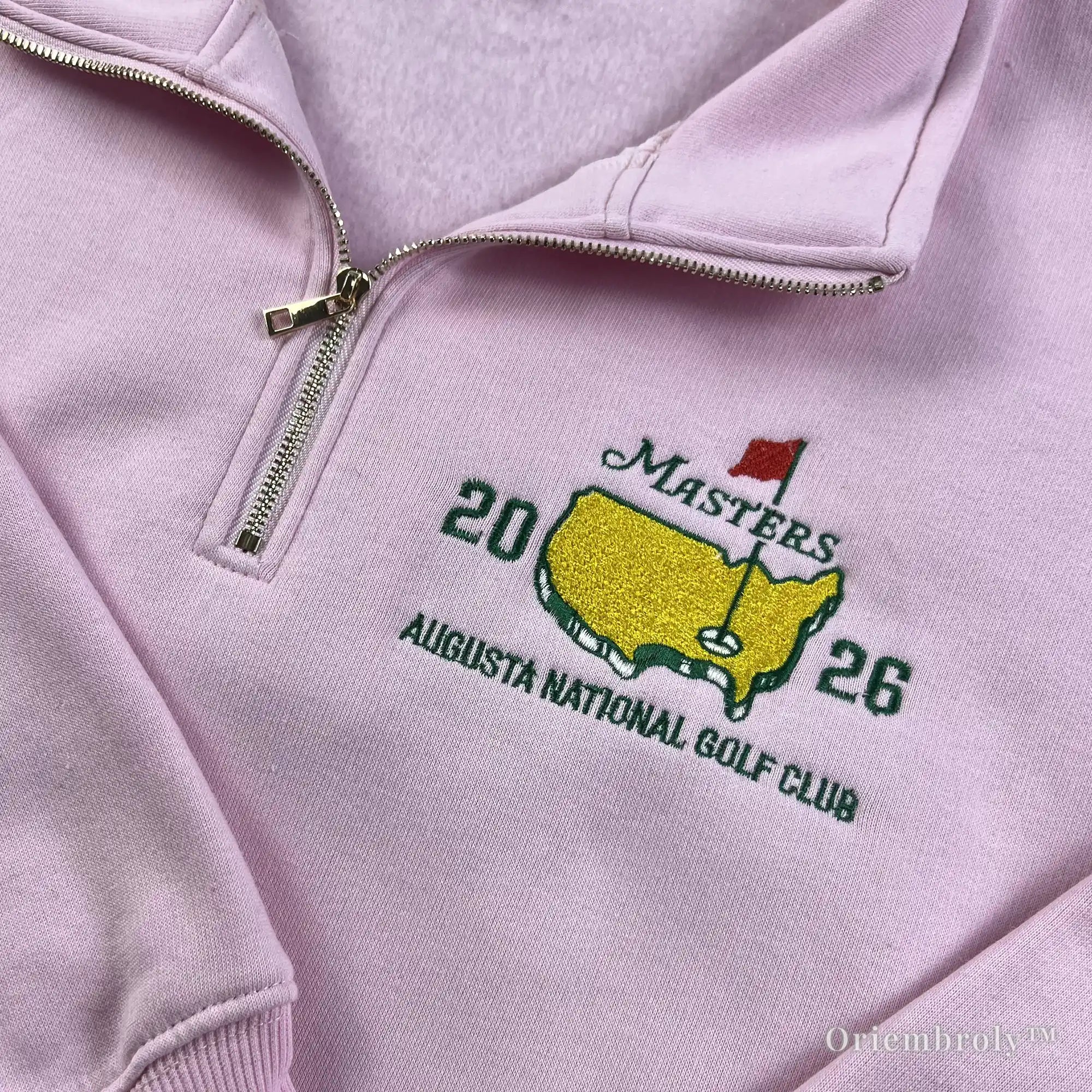Detailed Masters 2026 embroidery on a soft pink quarter-zip sweatshirt. A thoughtful and stylish gift idea for female golfers, mothers, or sports enthusiasts